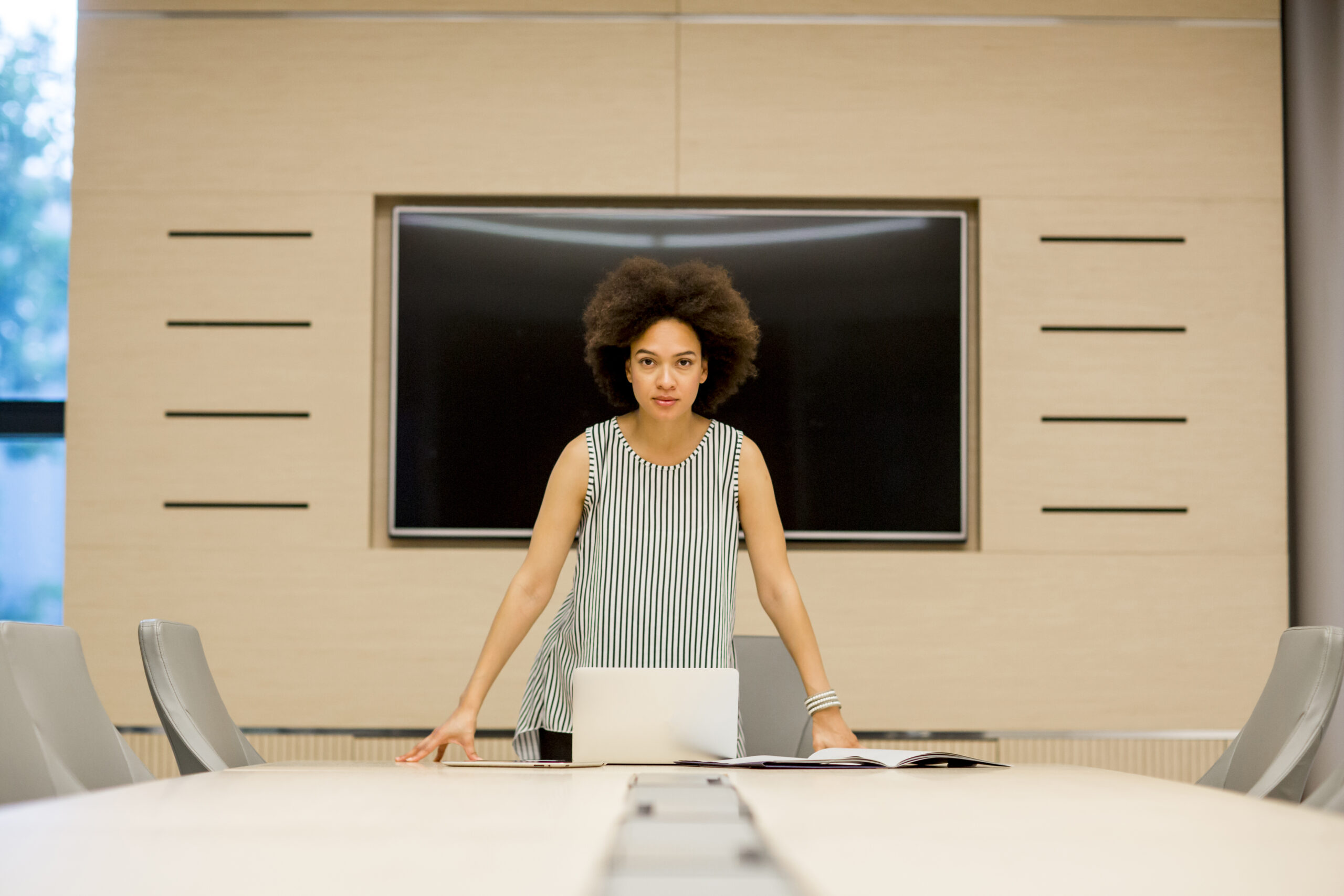 Young african american woman standing  in a modern office, Business concept.