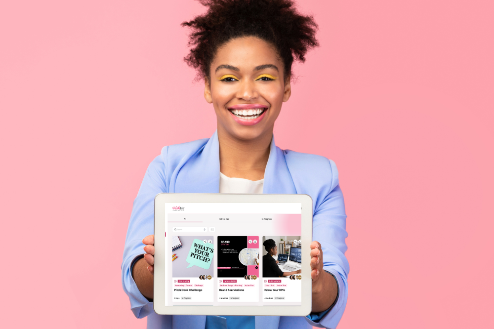 A Black women entrepreneur showing an online platform, symbolizing empowerment and community support within Sistahbiz Workgroups.